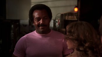 Movie still from “Fingers” (1978), directed by James Toback – A man and a little girl are standing in a room; Close Up shot, Low angle