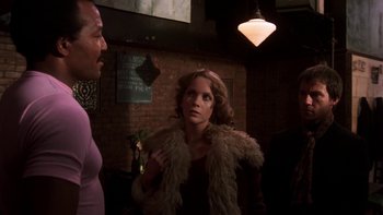 Movie still from “Fingers” (1978), directed by James Toback – A woman wearing a fur coat talking to a man in a room; Medium shot, Over the shoulder angle