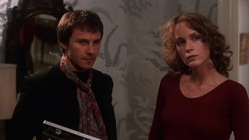 Movie still from “Fingers” (1978), directed by James Toback – A man and a woman standing next to each other; Close Up shot, Low angle