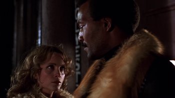 Movie still from “Fingers” (1978), directed by James Toback – A man and a woman in fur coats looking at each other; Close Up shot, Low angle