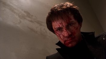 Movie still from “Fingers” (1978), directed by James Toback – A person with blood all over his face; Close Up shot, Low angle
