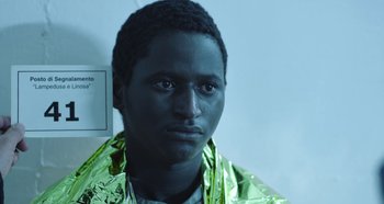 A young man wearing a shiny green jacket