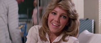 Movie still from “Firestarter” (1984), directed by Mark L. Lester – A person with long blonde hair; Close Up shot, Low angle