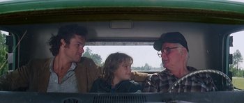 Movie still from “Firestarter” (1984), directed by Mark L. Lester – A group of people sitting in the back of a car; Medium shot, Over the shoulder angle