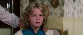 Movie still from “Firestarter” (1984), directed by Mark L. Lester – A young girl with blonde hair and a blue shirt; Close Up shot, Low angle