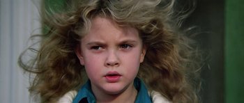 Movie still from “Firestarter” (1984), directed by Mark L. Lester – A young person with long blonde hair; Close Up shot, Low angle