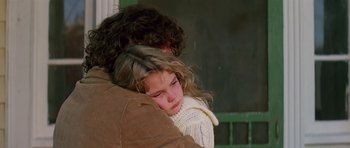 Movie still from “Firestarter” (1984), directed by Mark L. Lester – A young girl sitting on the shoulder of a man; Close Up shot, Over the shoulder angle