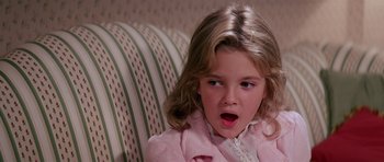 Movie still from “Firestarter” (1984), directed by Mark L. Lester – A little girl sitting on a couch with her mouth open; Close Up shot, High angle