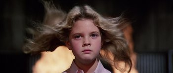 Movie still from “Firestarter” (1984), directed by Mark L. Lester – A young girl with long blonde hair flying in the wind; Close Up shot, Low angle