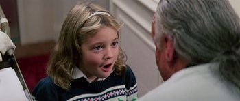 Movie still from “Firestarter” (1984), directed by Mark L. Lester – A little girl is talking to an older man; Close Up shot, Over the shoulder angle