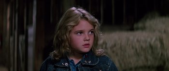 Movie still from “Firestarter” (1984), directed by Mark L. Lester – A young girl with long blonde hair looking to her left; Close Up shot, Low angle