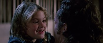 Movie still from “Firestarter” (1984), directed by Mark L. Lester – A young girl smiling at a man in a prison cell; Close Up shot, Over the shoulder angle