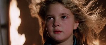 Movie still from “Firestarter” (1984), directed by Mark L. Lester – A young child's face with hair blowing in the wind; Close Up shot, Low angle