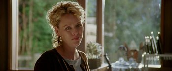 Movie still from “Firewall” (2006), directed by Richard Loncraine – A person sitting at a table near a window; Close Up shot, Over the shoulder angle