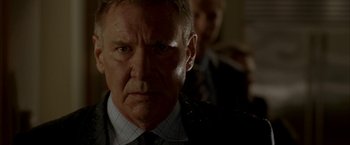 Movie still from “Firewall” (2006), directed by Richard Loncraine – A man in a suit and tie; Close Up shot, Low angle