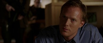 Movie still from “Firewall” (2006), directed by Richard Loncraine – A person sitting in a room; Close Up shot, Over the shoulder angle