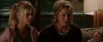 Movie still from “Firewall” (2006), directed by Richard Loncraine – Two women sitting next to each other in a room; Close Up shot, Over the shoulder angle