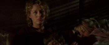 Movie still from “Firewall” (2006), directed by Richard Loncraine – A woman standing next to a child in a dark room; Close Up shot, Low angle