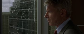 Movie still from “Firewall” (2006), directed by Richard Loncraine – A person looking out a window; Close Up shot, Low angle