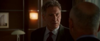 Movie still from “Firewall” (2006), directed by Richard Loncraine – A person wearing a suit and tie; Close Up shot, Over the shoulder angle