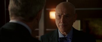 Movie still from “Firewall” (2006), directed by Richard Loncraine – A man wearing a suit and tie talking to another man; Close Up shot, Over the shoulder angle