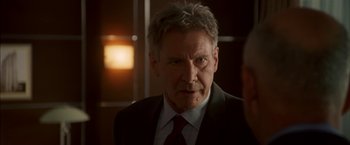 Movie still from “Firewall” (2006), directed by Richard Loncraine – A person wearing a suit and tie; Close Up shot, Over the shoulder angle