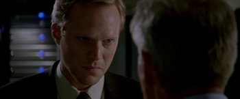 Movie still from “Firewall” (2006), directed by Richard Loncraine – A person wearing a suit and tie; Close Up shot, Over the shoulder angle