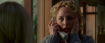 Movie still from “Firewall” (2006), directed by Richard Loncraine – A woman holding a phone up to her ear; Close Up shot, Low angle