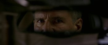 Movie still from “Firewall” (2006), directed by Richard Loncraine – An older man looking through the bars of a window; Extreme Close Up shot, Over the shoulder angle