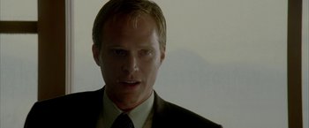 Movie still from “Firewall” (2006), directed by Richard Loncraine – A person wearing a suit and tie; Close Up shot, Low angle