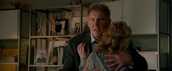 Movie still from “Firewall” (2006), directed by Richard Loncraine – A man and a woman are hugging in a room; Close Up shot, Over the shoulder angle