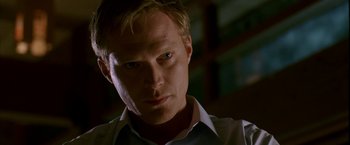 Movie still from “Firewall” (2006), directed by Richard Loncraine – A person wearing a white shirt; Close Up shot, Low angle