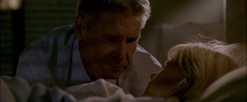 Movie still from “Firewall” (2006), directed by Richard Loncraine – A person looking at a book; Close Up shot, Over the shoulder angle