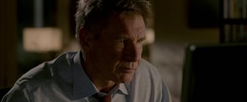Movie still from “Firewall” (2006), directed by Richard Loncraine – An older man wearing a shirt and a tie; Close Up shot, Over the shoulder angle
