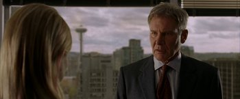 Movie still from “Firewall” (2006), directed by Richard Loncraine – Harrison ford in a suit and tie in front of a window; Close Up shot, Over the shoulder angle