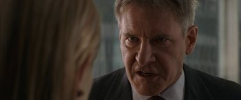 Movie still from “Firewall” (2006), directed by Richard Loncraine – A man in a suit and tie looking angry at a woman in a suit; Close Up shot, Over the shoulder angle