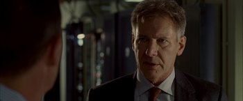 Movie still from “Firewall” (2006), directed by Richard Loncraine – A person wearing a suit and tie; Close Up shot, Low angle