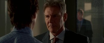 Movie still from “Firewall” (2006), directed by Richard Loncraine – A man wearing a suit and tie talking to another man in a suit; Close Up shot, Over the shoulder angle