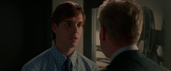 Movie still from “Firewall” (2006), directed by Richard Loncraine – A man in a suit and tie talking to another man in a suit and tie; Close Up shot, Over the shoulder angle
