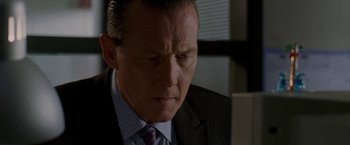 Movie still from “Firewall” (2006), directed by Richard Loncraine – A person wearing a suit and tie; Close Up shot, Low angle