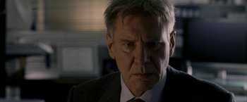 Movie still from “Firewall” (2006), directed by Richard Loncraine – A person wearing a suit and tie; Close Up shot, Over the shoulder angle