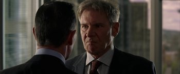 Movie still from “Firewall” (2006), directed by Richard Loncraine – A man in a suit and tie looking at another man in a suit and tie; Close Up shot, Over the shoulder angle