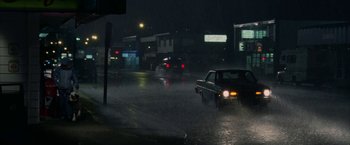 Movie still from “Firewall” (2006), directed by Richard Loncraine – A car driving down a flooded street at night; Extreme Wide shot, High angle