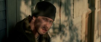 Movie still from “Firewall” (2006), directed by Richard Loncraine – A person wearing a hat; Close Up shot, Low angle