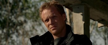 Movie still from “Firewall” (2006), directed by Richard Loncraine – A person wearing a black jacket; Close Up shot, Low angle