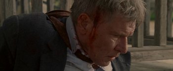 Movie still from “Firewall” (2006), directed by Richard Loncraine – A person with blood on his face; Close Up shot, Over the shoulder angle