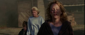 Movie still from “Firewall” (2006), directed by Richard Loncraine – Two women are standing outside in the sunlight; Close Up shot, Over the shoulder angle