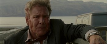 Movie still from “Firewall” (2006), directed by Richard Loncraine – A person wearing a suit and tie; Close Up shot, Low angle