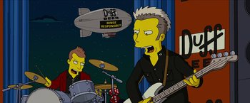 Movie still from “The Simpsons Movie” (2007), directed by David Silverman – A cartoon of a man playing a guitar while another man plays drums; Medium shot, Low angle