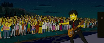 Movie still from “The Simpsons Movie” (2007), directed by David Silverman – A group of people standing in front of each other at night; Wide shot, High angle
